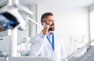 dentist on the phone with a patient