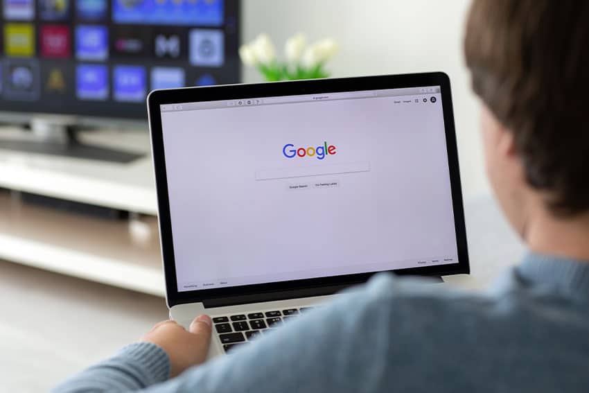 Pro-Tips–Google-Ads-for-Dental-Implants senior citizen searching on laptop, looking at Google