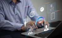 man typing on laptop with metrics and data