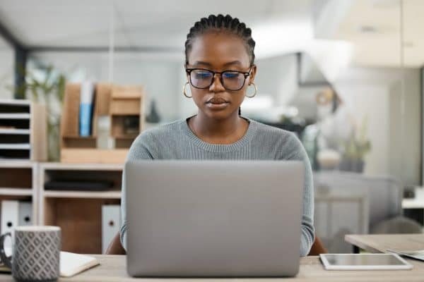 woman on computer looking to boost her dental seo on Google