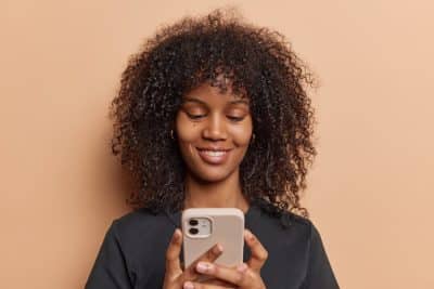 woman looking at a dental website on her phone