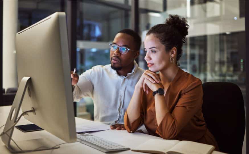 man and woman working at computer