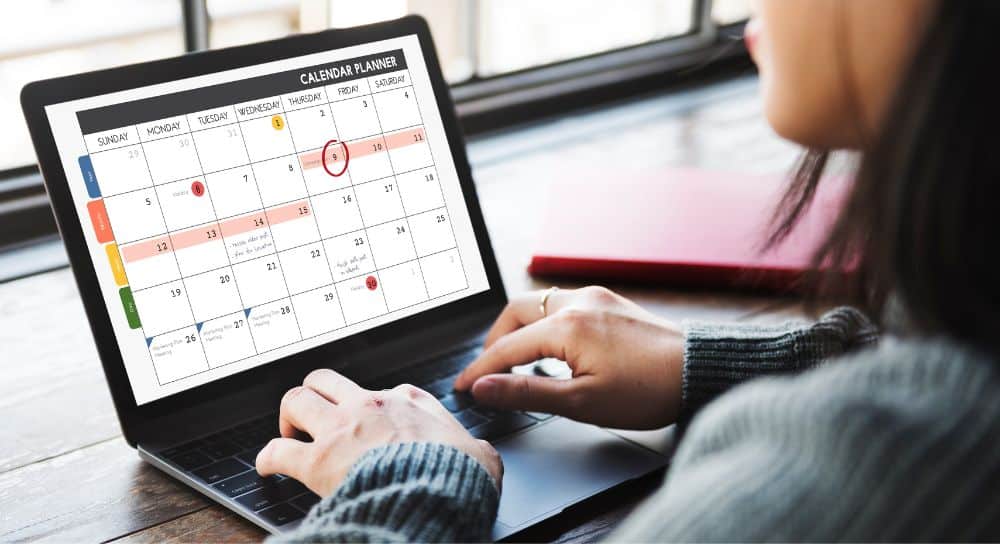 woman using a Social Media Content Calendar to plan her posts