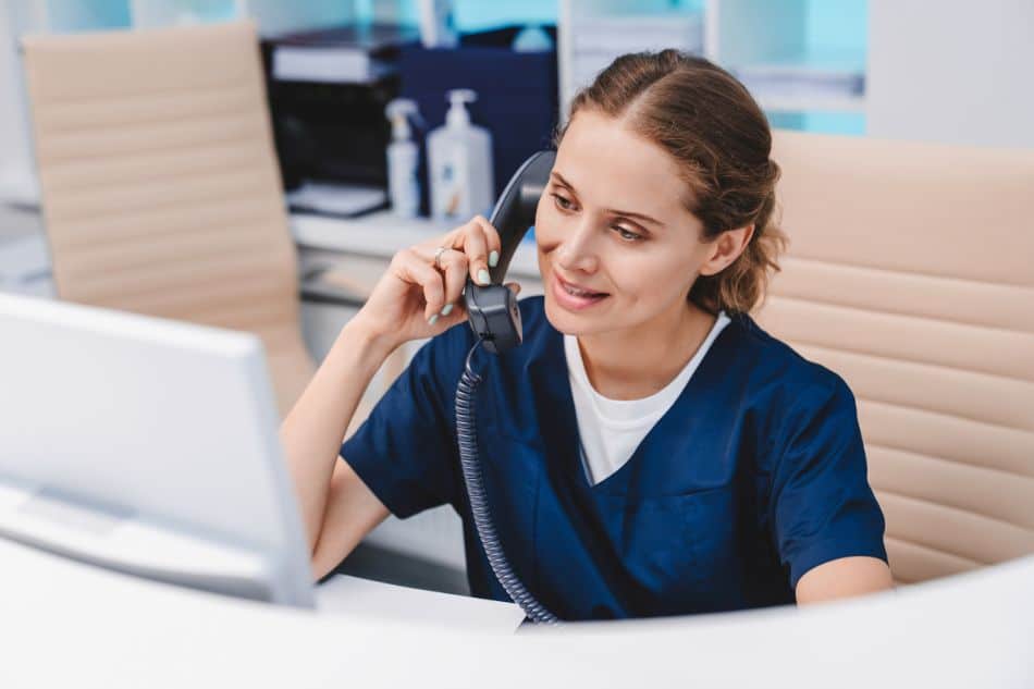 Dental receptionist on phone